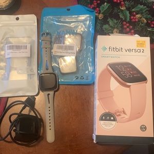 Fitbit Versa 2 Smartwatch (rose gold) comes with charger, and 4 cases